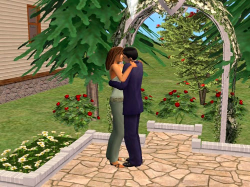 Jane and Martin kissing in front of the wedding arch